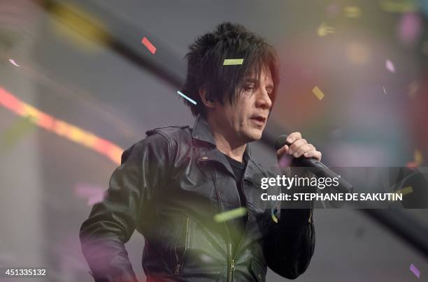 French singer Nicolas Sirkis from Indochine band gestures as he performs on June 27, 2014 during a concert at the Stade de France, in Saint-Denis,...