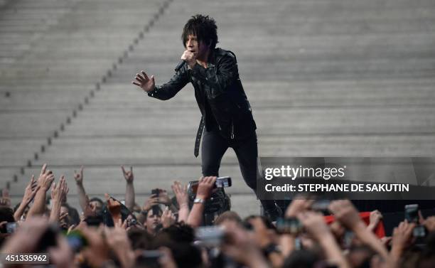French singer Nicolas Sirkis from the band Indochine performs on June 27, 2014 during a concert at the Stade de France, in Saint-Denis, north of...
