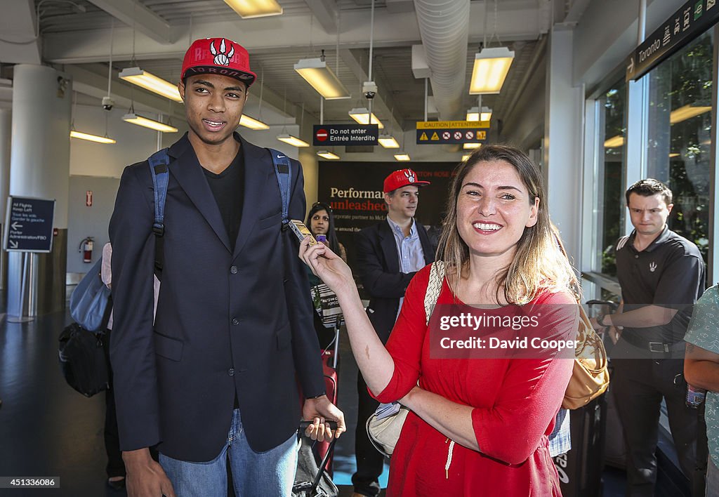 Brazilian Basketball player Bruno Caboclo drafted 20th over all by the Raptors arrives on Porter Airlines from Newark NJ at Billy Bishop Airport in Toronto. Toronto Star reporter Isabel Teotonio (in Red) talks to Bruno as he arrived.