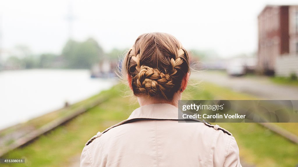 Girl with braids photographed from behind