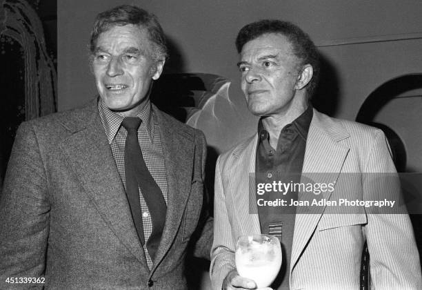 Actors Charlton Heston and Cornel Wilde at a party honoring Heston as the host of a tennis tournament benefiting the American Film Institute, on June...