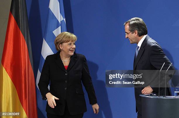 German Chanellor Angela Merkel and Greek Prime Minister Antonis Samaras depart afther they spoke to the media following talks at Chancellery on...