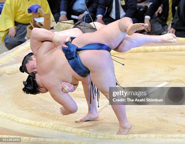 Mongolian yokozuna Hakuho , whose real name is Mnkhbatyn Davaajargal throws Goeido to win during the day twelve of the Grand Sumo Kyushu Tournament...