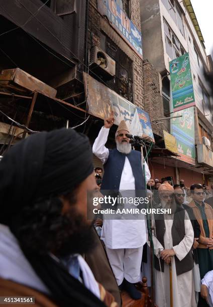 Maulana Mohammad Ahmed Ludhianvi, chief of Pakistani Sunni Muslim Islamic party Ahle Sunnat Wal-Jmaat, addresses supporters in front of a burned...