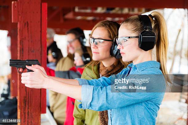 practicing at the shooting range - firing handgun stock pictures, royalty-free photos & images
