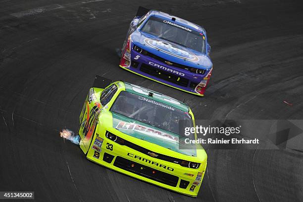 Paul Menard, driver of the Libman/Menards Chevrolet, races Kevin Harvick, driver of the Kroger/P&G Chevrolet, during the NASCAR Nationwide Series...