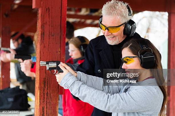 practicing at the shooting range - firing handgun stock pictures, royalty-free photos & images