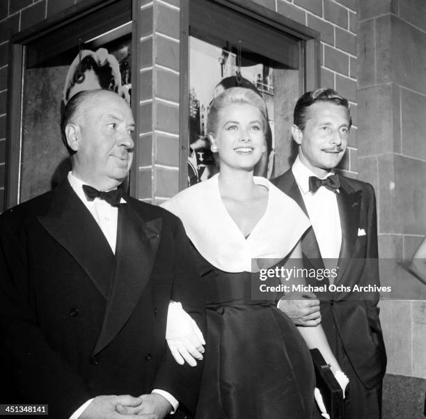 Director Alfred Hitchcock with actress Grace Kelly and Oleg Cassini at the premier of "Rear Window" in Los Angeles, California.