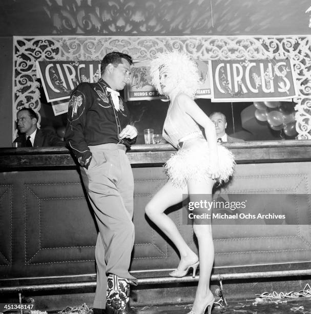 Conrad Hilton, Jr with guest attends Sonja Henie Circus party in Los Angeles, California.