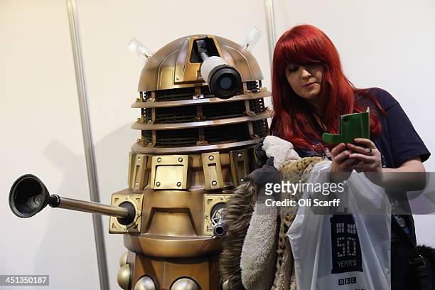 Doctor Who fan takes a 'selfie' photograph on her mobile phone with a Dalek at the 'Doctor Who 50th Celebration' event in the ExCeL centre on...