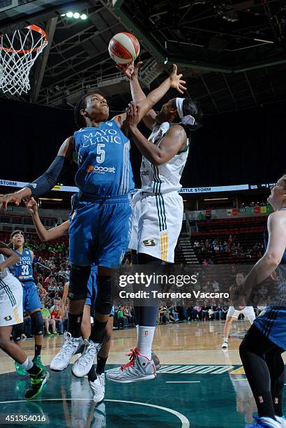 Noelle Quinn of the Seattle Storm shoots against Tan White of the Minnesota Lynx on June 27,2014 at Key Arena in Seattle, Washington. NOTE TO USER:...