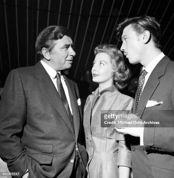 Actor Laurence Harvey with Robert Newton and Norma Brooks attend a Mike Todd party in Los Angeles, California.