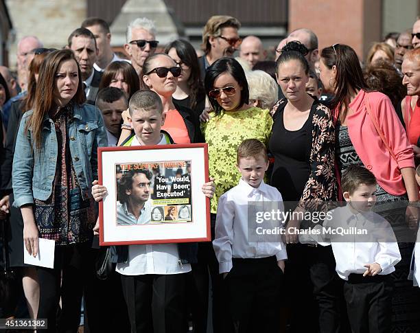 Family members watch as the coffin of Gerry Conlon is carried into St. Peter's Cathedral for a requiem mass on June 28, 2014 in Belfast, Northern...