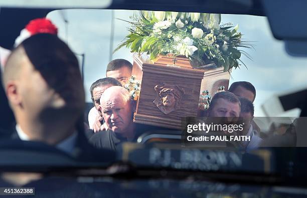 The coffin of Gerry Conlon is carried to the hearse from his home in west Belfast on June 28, 2014. Conlon, who wrongly spent 15 years in jail over a...