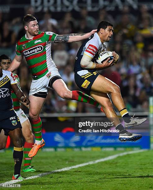 Matthew Wright of the Cowboys takes a high ball in his own in goal with Chris McQueen of the Rabbitohs during the round 16 NRL match between the...