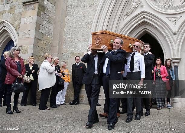 The coffin of Gerry Conlon is carred from St Peters Cathedral in west Belfast on June 28, 2014. Conlon, who wrongly spent 15 years in jail over a...