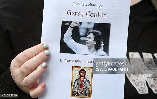Mourner holds an order of service for Gerry Conlon, outside St Peters Cathedral in Belfast on June 28, 2014. Conlon, who wrongly spent 15 years in...