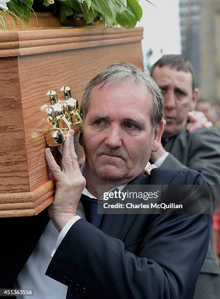 The coffin of Gerry Conlon is carried from St. Peter's Cathedral by fellow Guildfour Four member Paddy Armstrong after a requiem mass on June 28,...