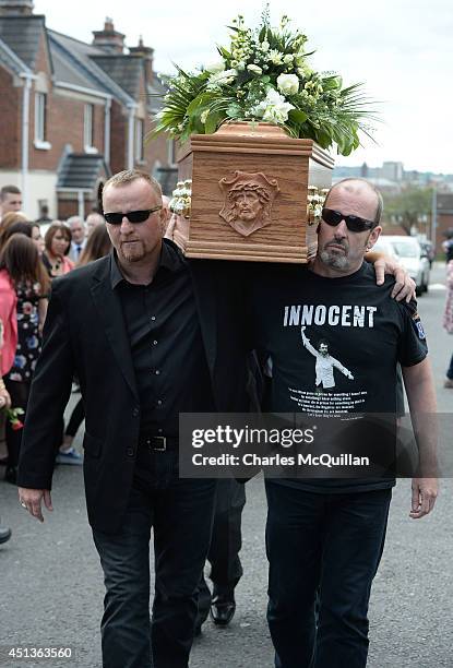 The coffin of Gerry Conlon is carried into St. Peter's Cathedral by friends, one wearing a t-shirt quoting Conlon on his release from prison, is...