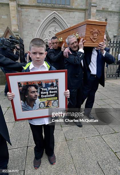 The coffin of Gerry Conlon is carried from St. Peter's Cathedral after a requiem mass by fellow Guildford Four member Paddy Armstrong and Paddy Hill...