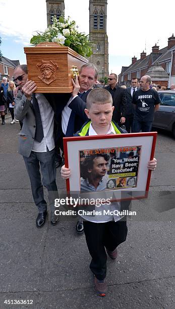 The coffin of Gerry Conlon is carried from St. Peter's Cathedral after a requiem mass by fellow Guildford Four members Paddy Armstrong as family...