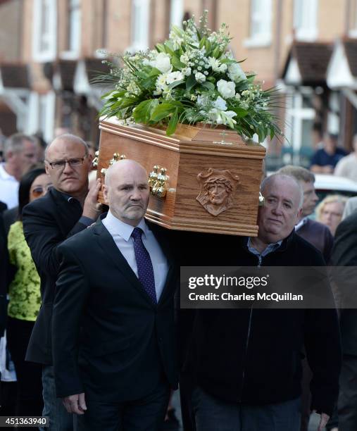 Sinn Fein MLA Alex Maskey carries the coffin of Gerry Conlon into St. Peter's Cathedral for a requiem mass on June 28, 2014 in Belfast, Northern...