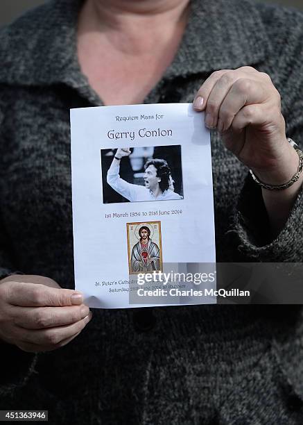 Woman holds a mass service card at the funeral of Gerry Conlon at St. Peter's Cathedral for a requiem mass on June 28, 2014 in Belfast, Northern...