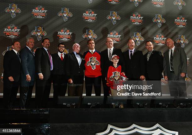 Aaron Ekblad poses with team personnel after being selected first overall by the Florida Panthers during the 2014 NHL Entry Draft at Wells Fargo...