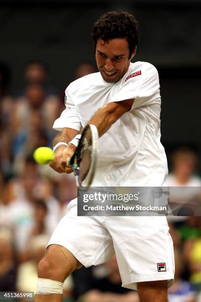 Mikhail Kukushkin of Kazakhstan plays a backhand return during his Gentlemen's Singles third round match against Rafael Nadal of Spain on day six of...