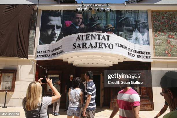 Visitors walk past a cinema that is showing a film about the assassination of Austrian Archduke Ferdinand by Serbian secessionist Gavrilo Princip in...