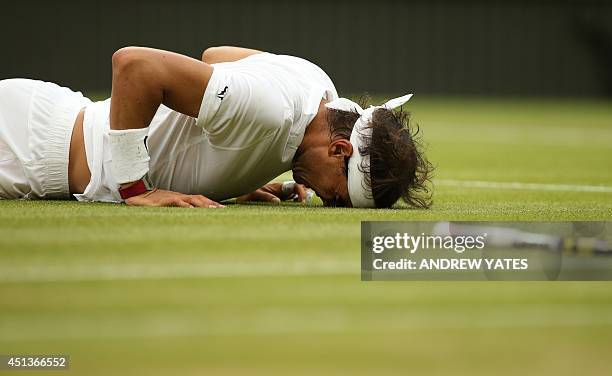 Spain's Rafael Nadal lies on the court after slipping during a point in his men's singles third round match against Kazakhstan's Mikhail Kukushkin on...