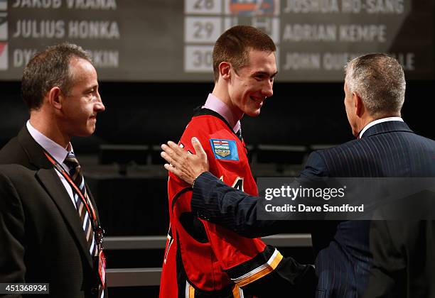 Mason McDonald greets his team after being selected 34th overall by the Calgary Flames during the 2014 NHL Entry Draft at Wells Fargo Center on June...