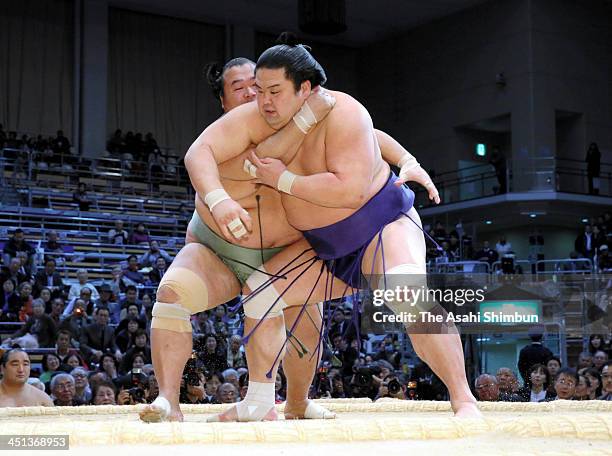 Toyonoshima pushes Myogiryu to win during the day eleven of the Grand Sumo Kyushu Tournament at Fukuoka Convention Center on November 20, 2013 in...