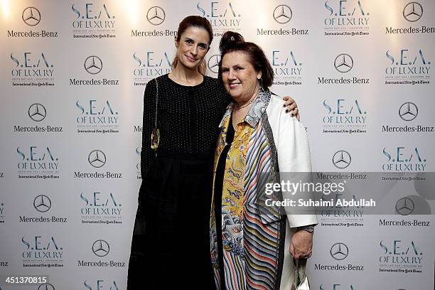 Olivia Firth and International New York Times International Fashion Editor, Suzy Menkes arrive at the Flower Dome on November 20, 2013 in Singapore....