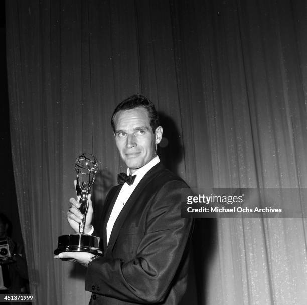 Actor Charlton Heston poses with a Emmy Award in Los Angeles, California.