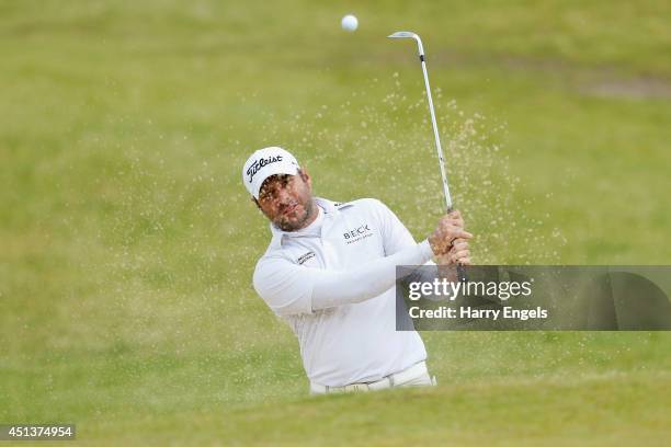 Terry Pilkadaris of Australia plays out of a bunker on day three of the 2014 Scottish Hydro Challenge hosted by MacDonald Hotels & Resorts at Spey...