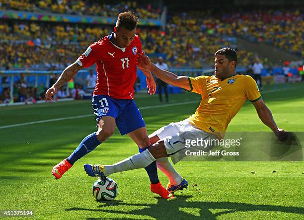 Hulk of Brazil challenges Eduardo Vargas of Chile during the 2014 FIFA World Cup Brazil round of 16 match between Brazil and Chile at Estadio...