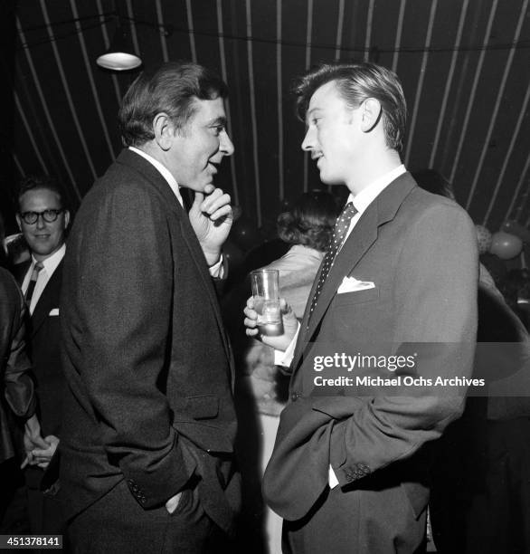 Actor Laurence Harvey with Robert Newton attend a Mike Todd party in Los Angeles, California.