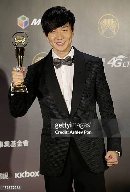 Singapore singer JJ Lin holds his award for Best Male Mandarin singer at the 25th Golden Melody Awards on June 28, 2014 in Taipei, Taiwan.