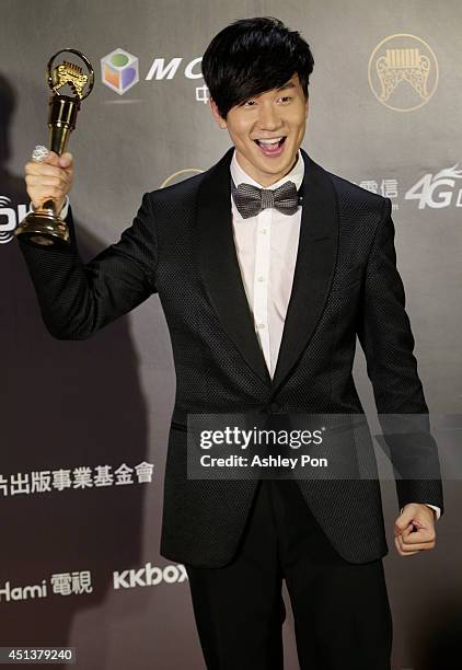 Singapore singer JJ Lin holds his award for Best Male Mandarin singer at the 25th Golden Melody Awards on June 28, 2014 in Taipei, Taiwan.