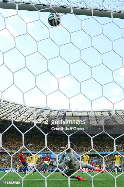 Mauricio Pinilla of Chile shoots and hits the cross bar as goalkeeper Julio Cesar of Brazil looks on during the 2014 FIFA World Cup Brazil round of...