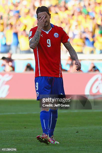 Mauricio Pinilla of Chile reacts after missing a penalty kick during the 2014 FIFA World Cup Brazil round of 16 match between Brazil and Chile at...