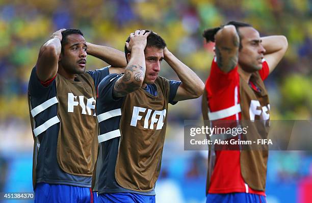 Jean Beausejour, Carlos Carmona and Jorge Valdivia of Chile looks on in front of the bench during the 2014 FIFA World Cup Brazil Round of 16 match...