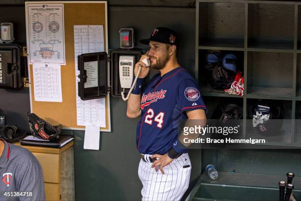 Trevor Plouffe of the Minnesota Twins makes a call to the bullpen against the Houston Astros on June 6, 2014 at Target Field in Minneapolis,...