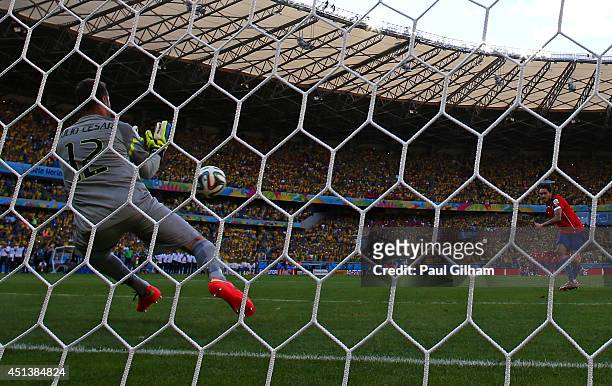 Julio Cesar of Brazil saves a penalty kick from Mauricio Pinilla of Chile during the 2014 FIFA World Cup Brazil round of 16 match between Brazil and...