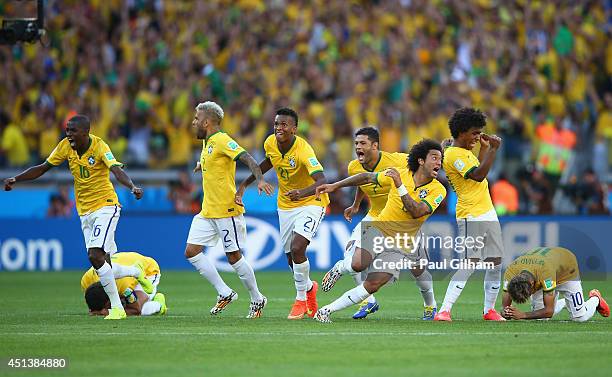 Brazil celebrate after defeating Chile in a penalty shootout during the 2014 FIFA World Cup Brazil round of 16 match between Brazil and Chile at...