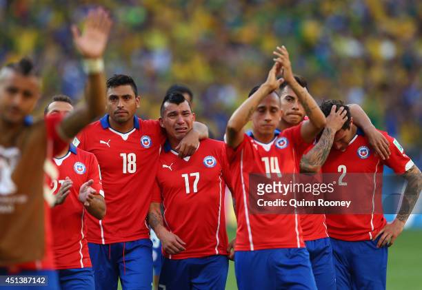 Gonzalo Jara, Gary Medell, Fabian Orellana, Eduardo Vargas and Eugenio Mena of Chile react after being defeated by Brazil in a penalty shootout...