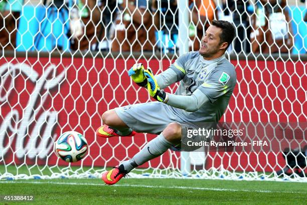 Julio Cesar of Brazil saves a penalty kick from Mauricio Pinilla of Chile in a penalty shootout during the 2014 FIFA World Cup Brazil Round of 16...