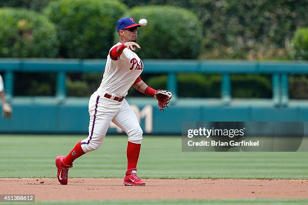 Ronny Cedeno of the Philadelphia Phillies throws the ball to first in the first inning of the first game of a doubleheader against the Atlanta Braves...