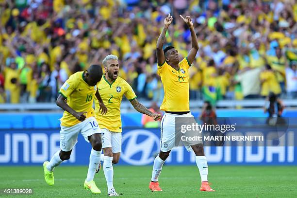Brazil's midfielder Ramires, Brazil's defender Dani Alves and Brazil's forward Jo celebrate after winning their match against Chile in a penalty...